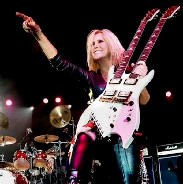 Photo of Lita Ford Pointing to Crowd with Double Neck Guitar