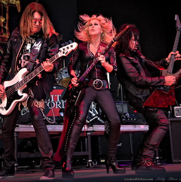 Photo of Martin, Lita, and Patrick Rocking Out on Stage
